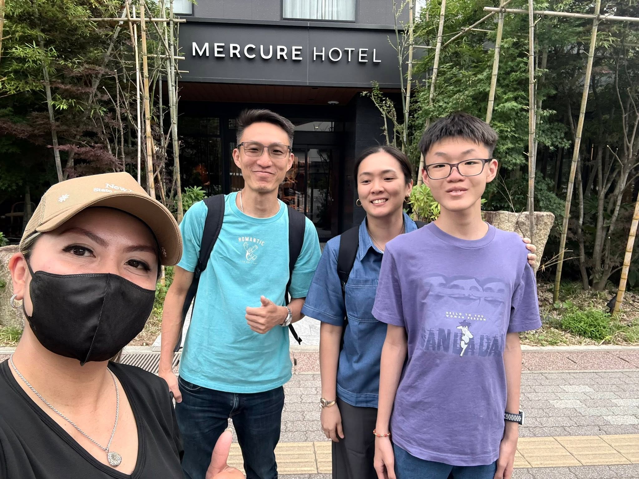 GG with travelers outside a hotel in Japan