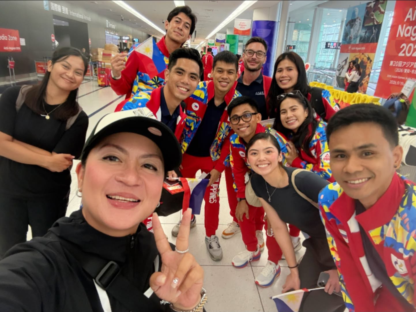 GG with travelers in an airport terminal
